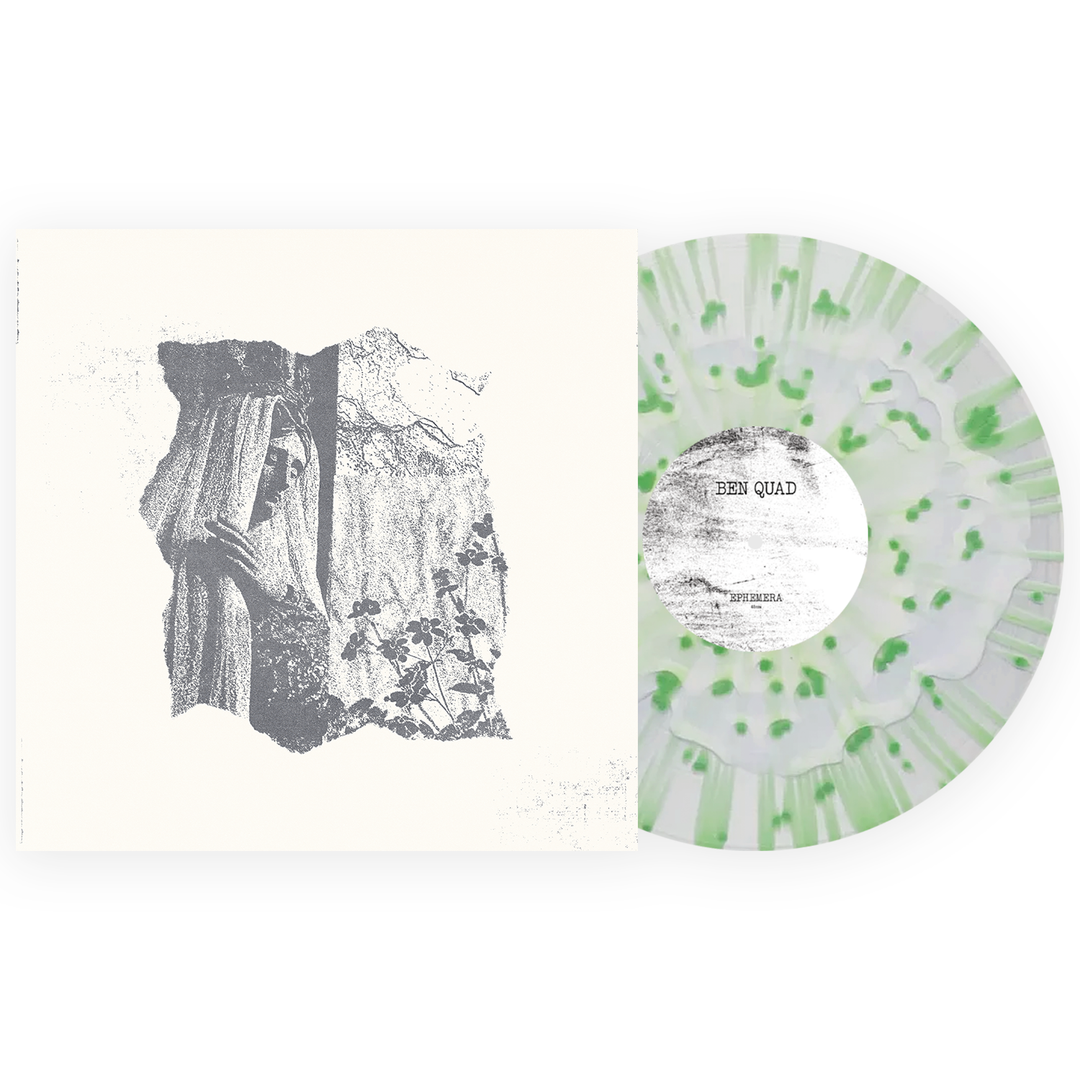 Clear vinyl record with green speckles next to its album cover artwork.